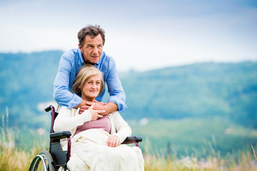Man with woman in wheelchair