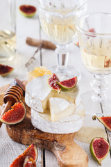 Cheese Board,Camembert with figs and honey and white wine.selective focus.