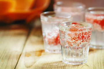 Fototapeta na wymiar Soda with pink grapefruit in glasses on an old wooden table, sel