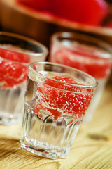Soda with pink grapefruit in glasses on an old wooden table, sel