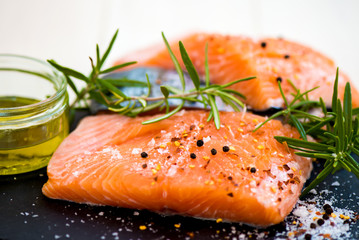 Portions of Fresh Raw Salmon Fillets with Aromatic Herbs and Oli