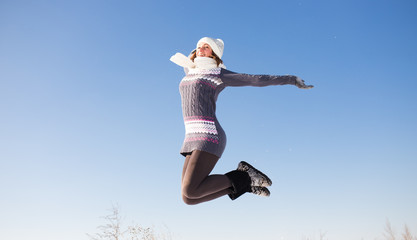 Young beautiful woman having fun at bright winter day