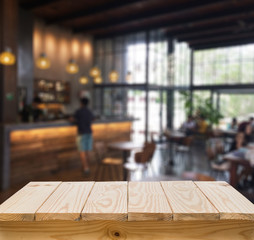 Wood table with blur coffee shop background