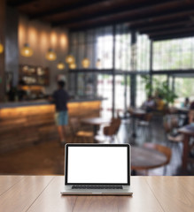 Blank screen laptop computer with blur coffee shop background