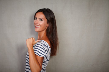 Brunette lady standing against grey background