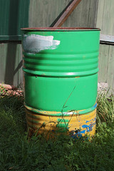 old colored barrel near the wall