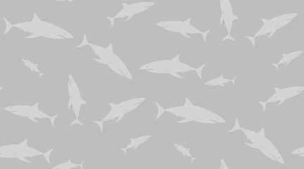 Vector seamless pattern of sharks. Sharks are located randomly on a gray background.