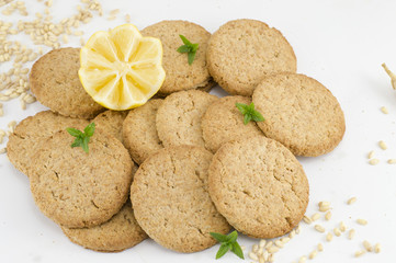 Integral cookies and decorated lemon on white background