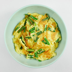 The homemade green onions omelet in green bowl.