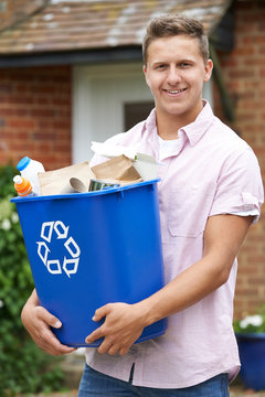 Portrait Of Man Carrying Recycling Bin