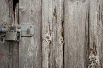 Old wooden door with a padlock