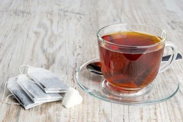 tea bags and transparent cup with tea