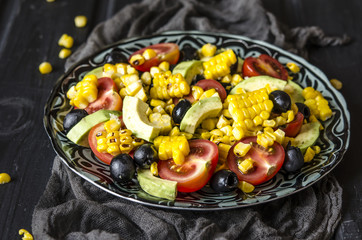 Salad with tomatoes and olives avocado grilled corn with mayonnaise   