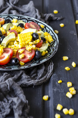 Salad with tomatoes and olives avocado grilled corn with mayonnaise   