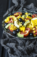 Salad with tomatoes and olives avocado grilled corn with mayonnaise   