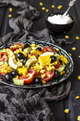 Salad with tomatoes and olives avocado grilled corn with mayonnaise   