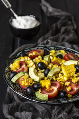 Salad with tomatoes and olives avocado grilled corn with mayonnaise   