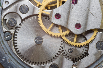 Metal cogwheels inside clockwork. Macro.