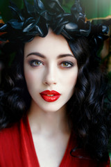 Portrait of a beautiful young woman in a wreath on had
