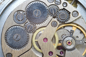  Metal cogwheels inside clockwork. Macro.