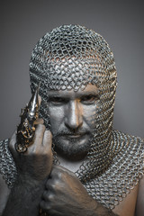 man in chain mail and leather painted silver, medieval warrior