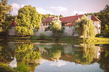 Grad Otocec, castle and its reflection in the middle of the river Krka.