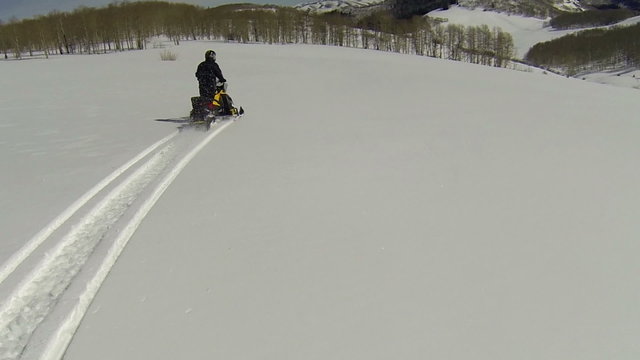 Winter recreation fun snowmobile across mountain top HD 012
