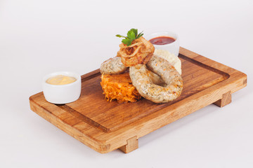 sausages with braised cabbage, wooden board, isolated, white