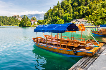 Wooden Tourist Boat on Shore of Bled Lake, Slovenia with Bled Castle in Background
