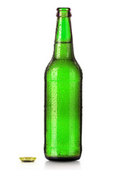 Bottle of beer with drops isolated on white
