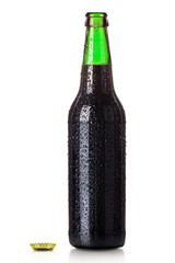 Bottle of beer with drops isolated on white