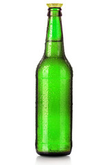 Bottle of beer with drops isolated on white
