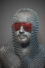 man in chain mail and leather painted silver, medieval warrior