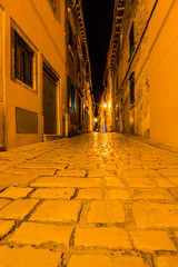 Narrow street in night of old town of Rovinj, Croatia