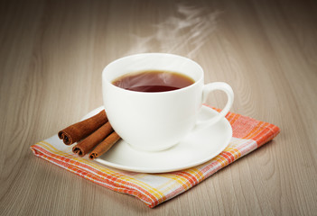 Hot cup of warming tea with cinnamon