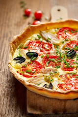 Vegetarian tart with tomato, onion, black olives, fresh chives