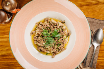 Oatmeal porridge with meat beef and glass of milk