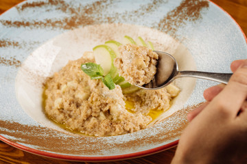 Oatmeal porridge with apple and glass of milk