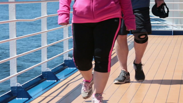 Couple walking on cruise ship deck for exercise HD 7832