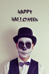 text happy halloween and man with calaveras makeup