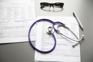 Stethoscope on the grey desk, close up