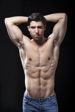 muscular torso of man on black bakground