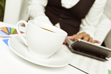 businesswoman using an electronic calculator in her office