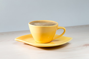 Yellow Cup of coffee on the table