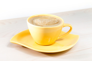 Yellow Cup of coffee on the table