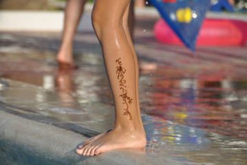 Henna tattoo on the leg of a young girl