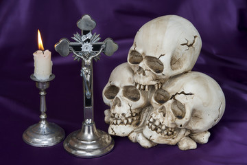 Crucifix and weathered human skull - Halloween background