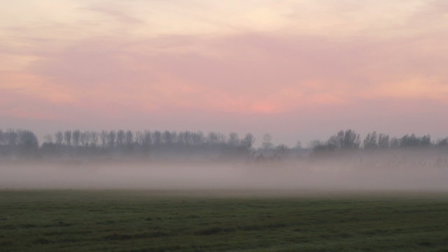 Sunset in a foggy winter landscape