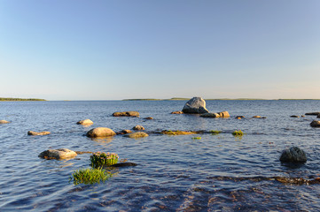 Large stones on seashore, sunset