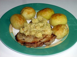 Pork steak fried with young roasted whole potatoes and gravy